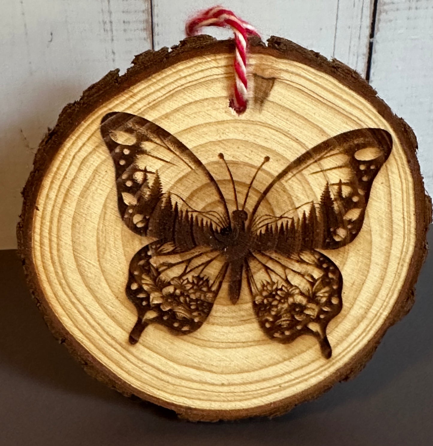 Engraved Live Edge Wooden Round Ornament - Butterfly with Inner Wilderness Scene