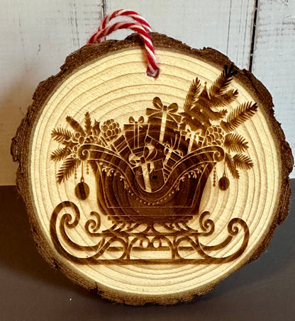 Engraved Live Edge Wooden Round Ornament - Presents and Pine in Sleigh